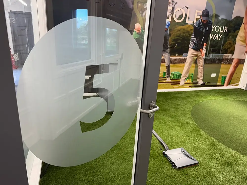 Glass signage panel at the St Andrews Links Golf Academy